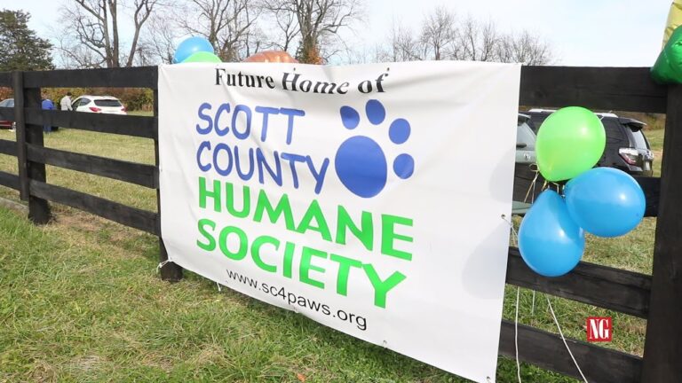A banner on a black fence reads "Future Home of Scott County Humane Society"