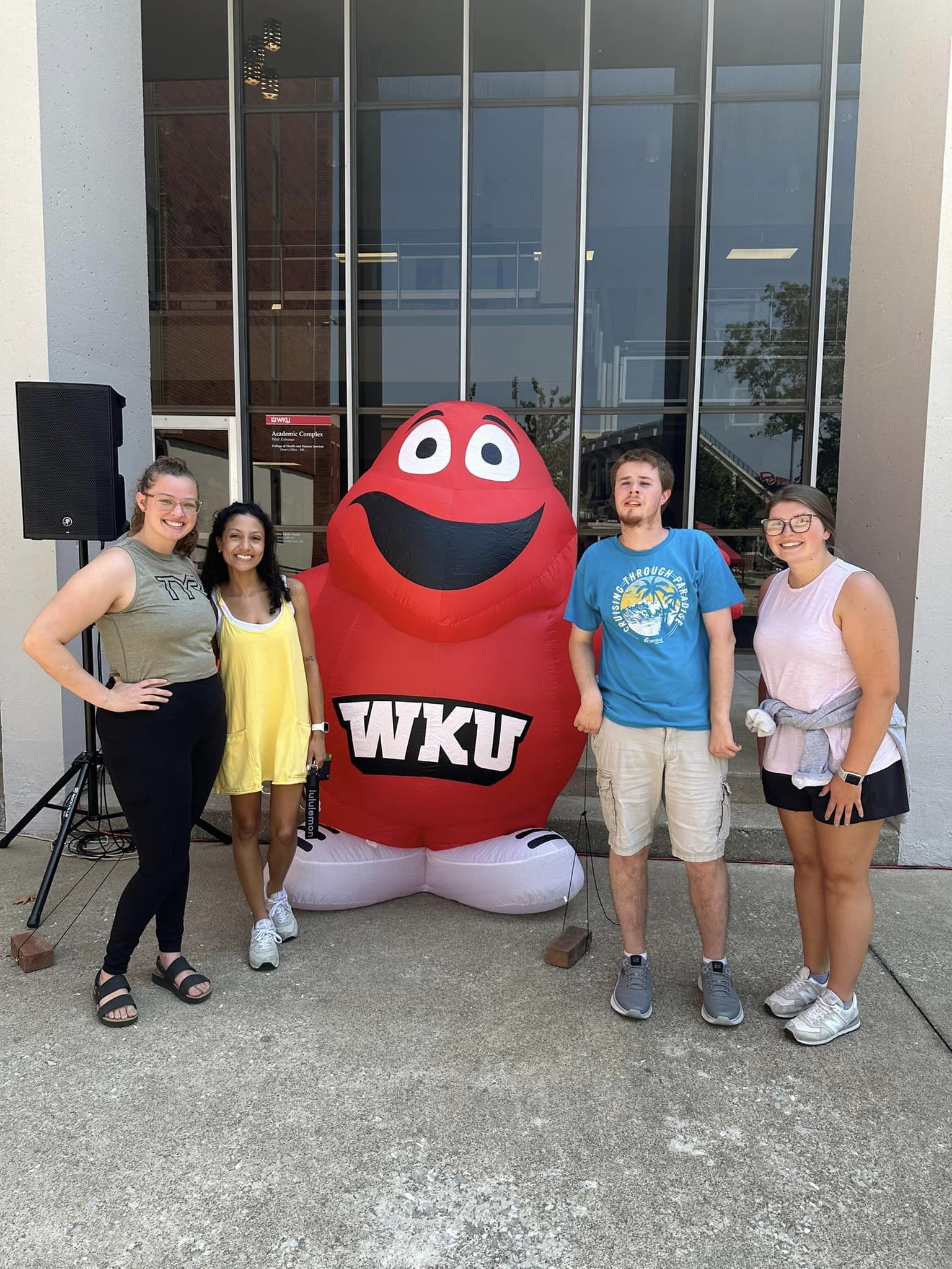 Group of people standing with the WKU Hilltopper